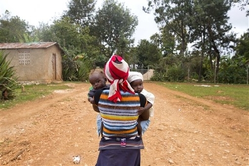 In this Feb. 15, 2016 photo, Carole Joseph holds her toddler twins, Angelo, left, and Angela, after visiting a local health center to examine her children for signs of malnutrition, in Oriani, Haiti. (Photo: AP)