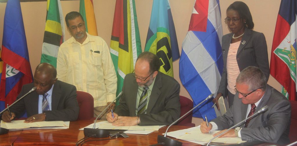 Signing the Agreement: (from left) Guyana’s Minister of Foreign Affairs Mr. Carl Greenidge; CARICOM Secretary-General Ambassador Irwin LaRocque; Cuba’s Ambassador to Guyana Mr. Julio Cesar Gonzalez Marchante