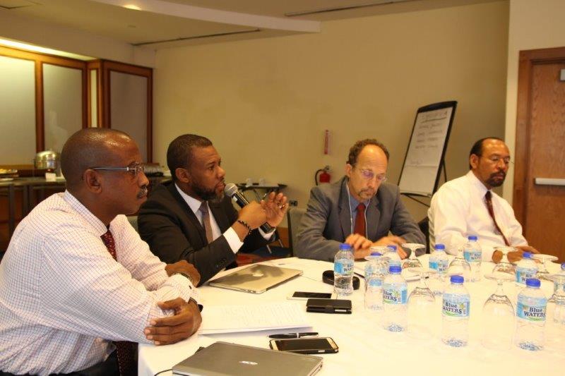 Mr. Ronald Jackson, second from left makes a point during the meeting