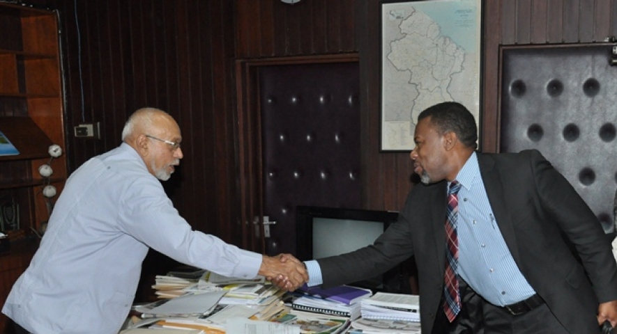 President Donald Ramotar greets Ronald Jackson, Executive Director, Caribbean Disaster Emergency Management Agency (CDEMA) (photo via GINA) 