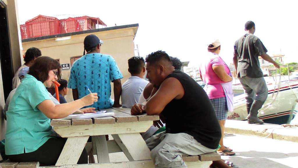 Claudia Stella Beltrán Turriago, economic consultant, interviewing fishers at Northern Fishermen's Cooperative in Belize City, Belize (Photo via CRFM)