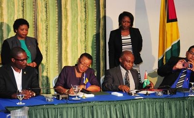 Minister of Foreign Affairs and Foreign Trade, Senator Maxine McClean and Guyana's Vice President and Minister of Foreign Affairs, Carl Greenidge signing the Joint Commission at Accra Beach Resort recently. (Photo by B.Hinds via BGIS)