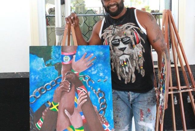 Belize What CARICOM Means to Me – artist and his painting 1