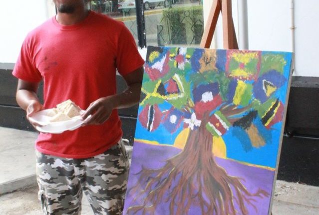 Belize What CARICOM Means to Me – artist and his painting 2