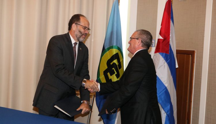 CAriCOM-Cuba signing ceremony – Hnadshake between SG and Amb. Marchante