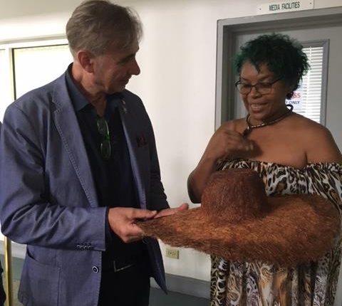 CFXIII Carol Fraser hands over a designer hat to Roberto Corbelli