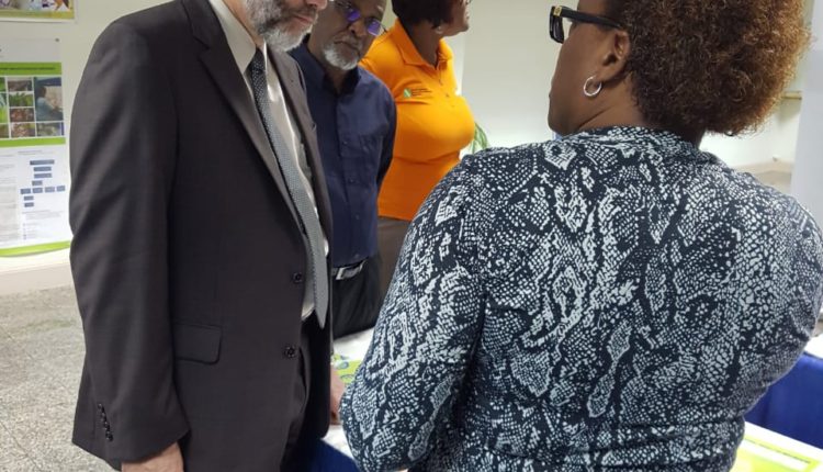 CWA MarketPlace SG, LR listen intently to officer at CAHFSA booth
