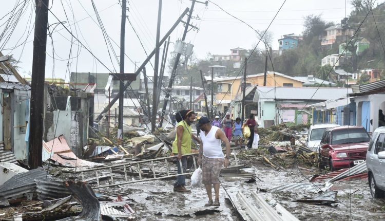 Dominica after Hurricane Maria people navigating debros strewn streets