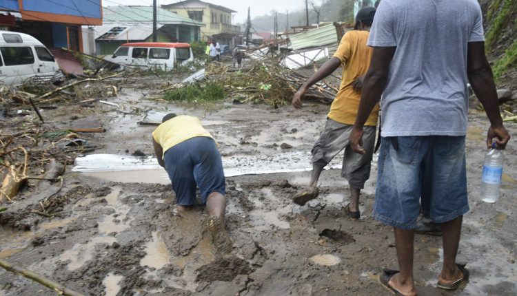 Dominica after Hurricane Maria people wade through slush