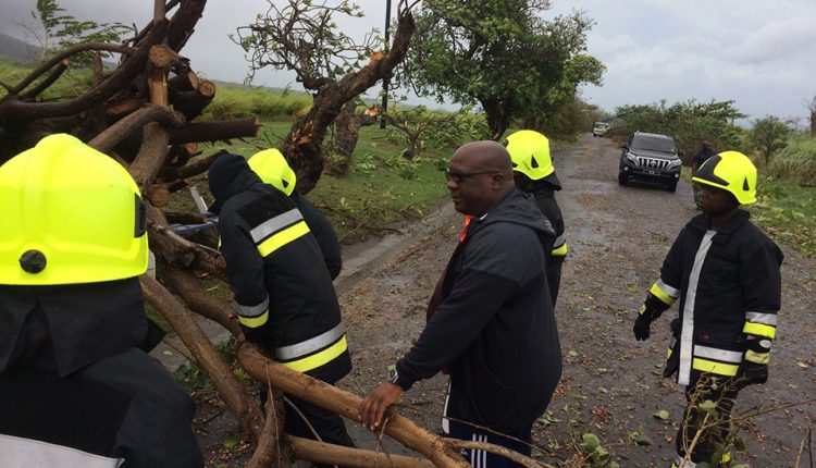 Irma_PM Harris assisting officers of the Fire and Rescue Services clear the island main road of debris