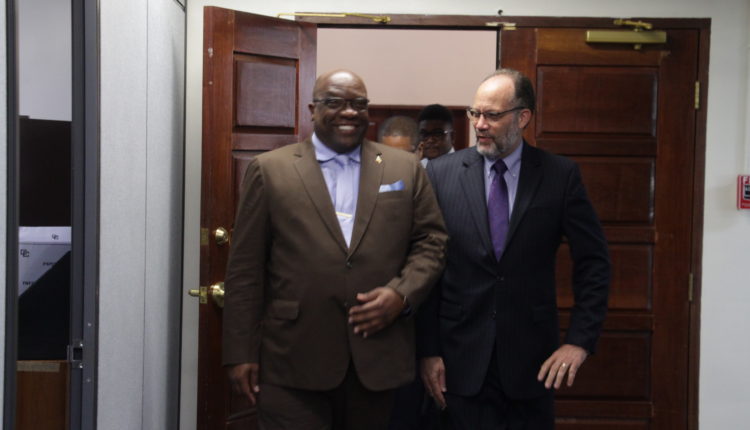 PM Harris smiles as SG escorts him