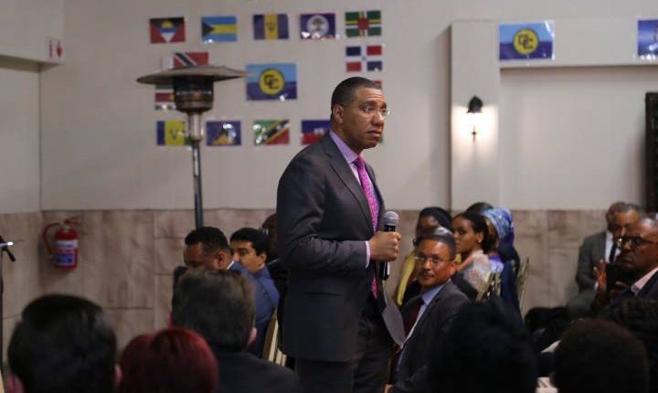 PM Holness walks in audience in South Africa